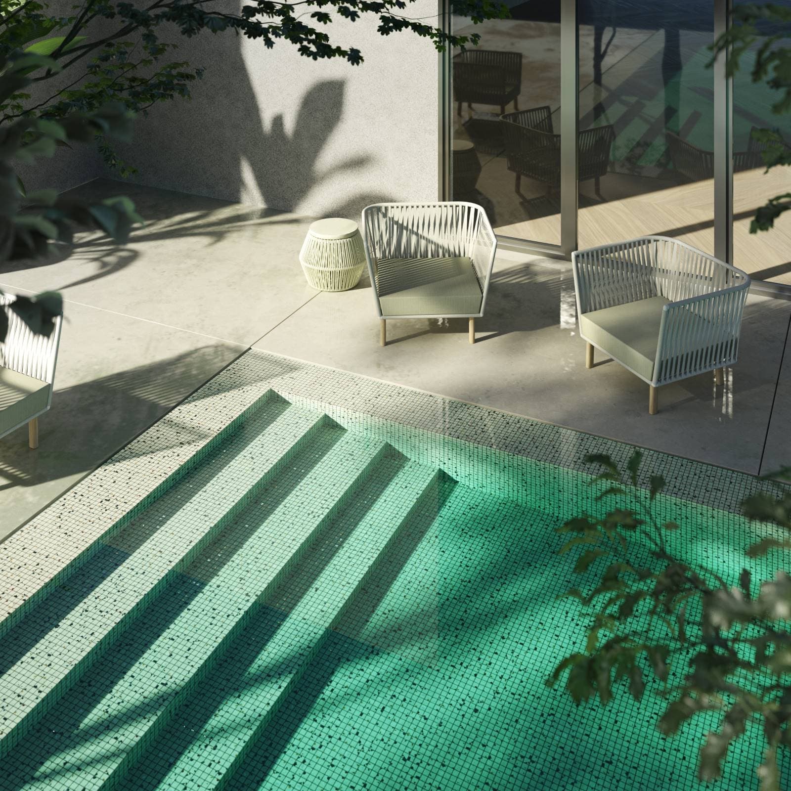 Uteområde med basseng og terrasse sett ovenfra. Området fremstår elegant og med gjennomtenkte materialer i lyse toner.